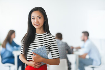 Beautiful asian businesswoman in front of her team