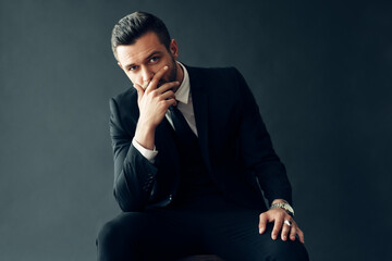 Elegant young man portrait on black background