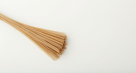 Buckwheat noodle bunch resting on a matte white surface