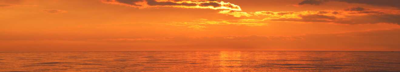 Obraz premium Batumi Black Sea coast Georgia Golden sunset over a calm sea Water surface during sunset with colorful sky and calm waves, suitable for layout backgrounds, World Oceans Day