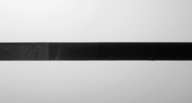 Black gaffer tape strip stretched across blank clean area