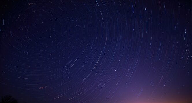 Long exposure star trails swirling in the dark night sky