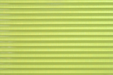 Obraz premium A macro shot of a light green transparent plastic surface with a horizontal ribbed pattern creating a clean and modern industrial background