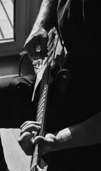 Electric Guitar Player Hands Close-Up in Dramatic Black and White
