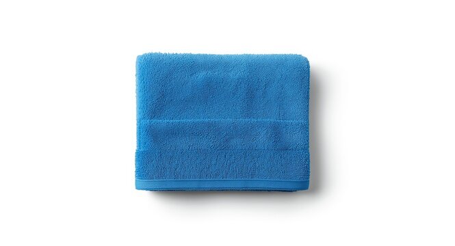 Blue towel folded in a compact shape on a smooth white backdrop shot from an overhead angle with natural light