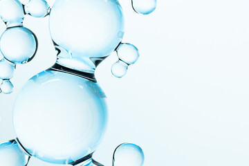 Abstract blue molecules on white background. 3D render of glossy liquid molecular structure, science and skincare concept with transparent spheres and copy space for modern design. © Iana Kunitsa