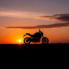Fototapeta premium A motorcycle silhouetted against a vibrant sunset in the countryside