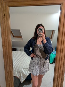 young woman posing for mirror selfie outfit