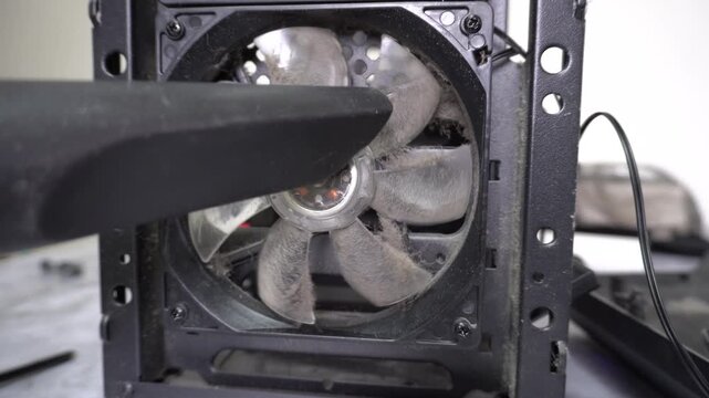 Cleaning the computer fan from dust with a vacuum cleaner. Maintenance of the system unit, removal of impurities from the cooling cooler, care of computer equipment at home.