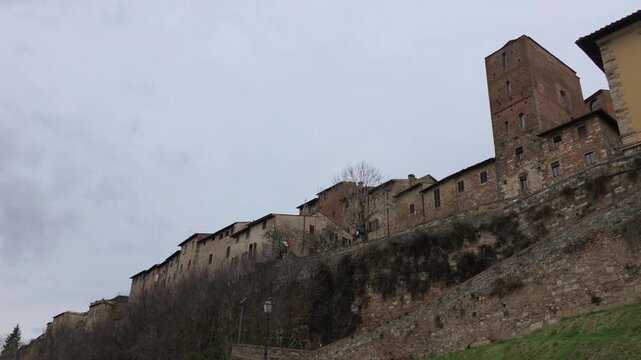 The ancient heart of Colle Val d'Elsa stands tall through the winter mist. Grey stone towers and narrow alleys overlook the valley, wrapped in a melancholic, silent charm
