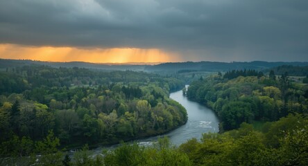 Beautiful spring landscape with river valley and lush green forests under rain clouds