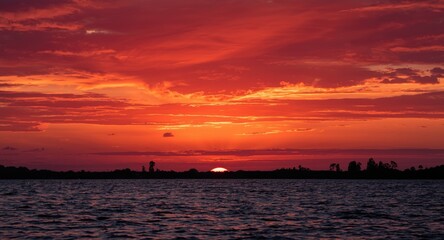 Beautiful crimson sunset over serene horizon
