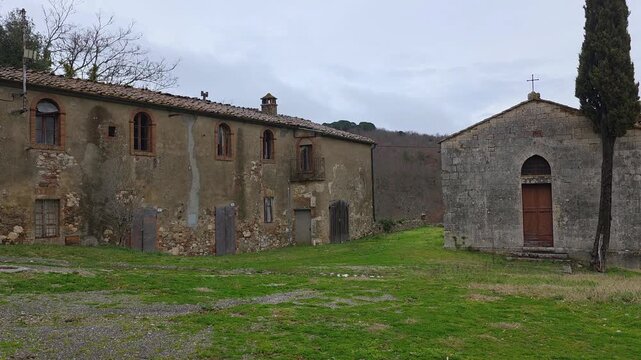 View of Frosini, a timeless Tuscan gem. Its medieval castle, once a Templar stronghold, towers over the Merse Valley, blending ancient stone walls with serene, rolling landscapes