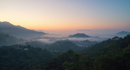 Obraz premium Early morning tropical mountain scene with fog and warm mist copy space