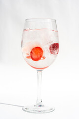 Fruits in a clear glass  on a white background