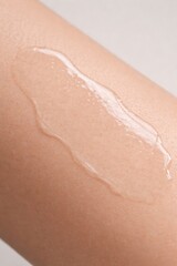 Fototapeta premium Liquid Gel Serum Texture on Human Skin, Skincare Product Macro