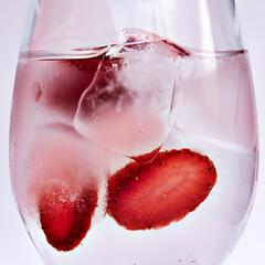 Fruits in a clear glass  on a white background