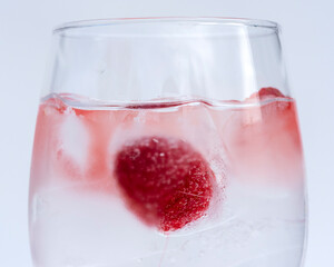 Fruits in a clear glass  on a white background