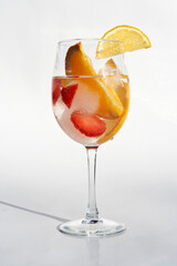 Fruits in a clear glass  on a white background