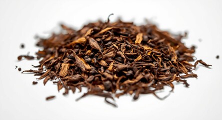 High detail close shot of Assam tea leaves pile on a white backdrop