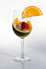 Fruits in a clear glass  on a white background
