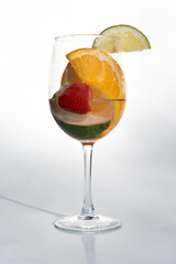 Fruits in a clear glass  on a white background