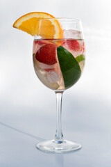 Fruits in a clear glass  on a white background