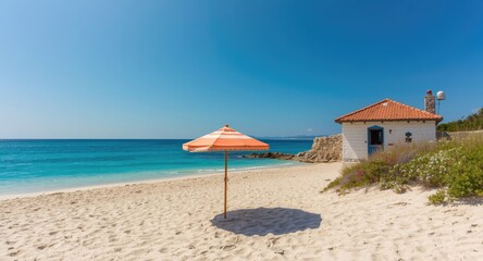 Fototapeta premium Holiday beach scene with sun umbrella and quaint house near blue ocean waters