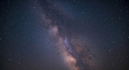 Fototapeta premium Clear winter evening displaying a glowing milky way and bright stars in deep space