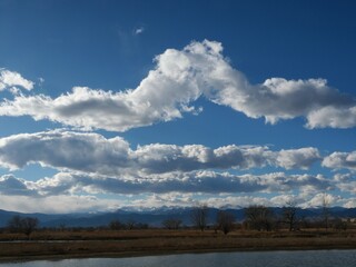 Dramatic Clouds Floating Above the Flatirons and Indian Peaks Wilderness in Early Spring Colorado