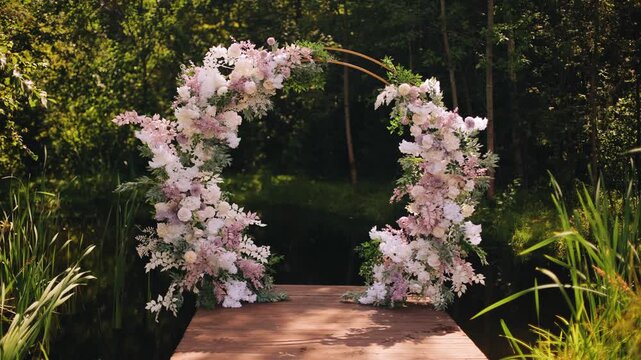 The wedding arch stands on a small pier on the shore of the pond. Shooting in the sun