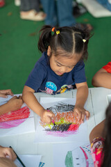 Adorable little asian preschool girl enjoy drawing pencil color paint on paper