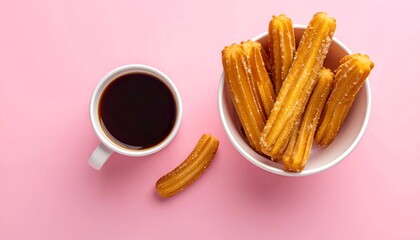Churros piled in a bowl with a coffee mug on a bright pink background
