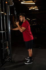 Athletic Man Performing Triceps Pushdown Exercise on Cable Machine