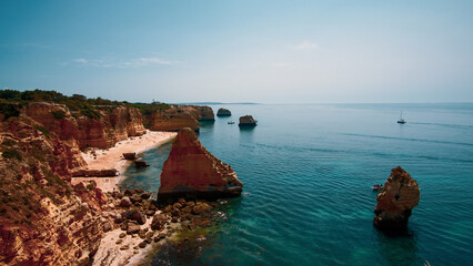 Beachgoers enjoy idyllic conditions at Praia de Marinha in Portugal