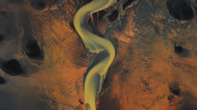Aerial view of braided river patterns creating a surreal landscape of winding waterways and textured earth tones, Selfoss, Iceland.