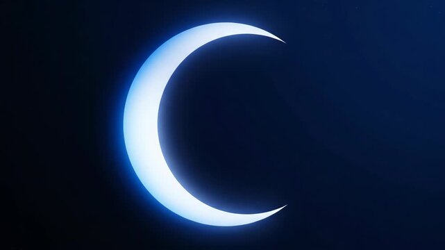 Crescent moon glowing brightly in a dark blue night sky captured from a terrestrial viewpoint