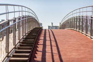 Empty pedestrian overpass with stairs and red walkway
