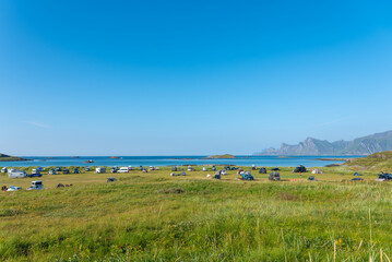 Fototapeta premium Campsite at Yttersand beach near Fredvang. The Norwegian Sea in the background.. Lofoten in Norway.