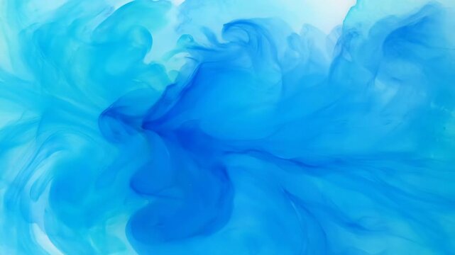 Blue ink swirls and dissolves in clear liquid. Abstract fluid art creates mesmerizing patterns and textures.