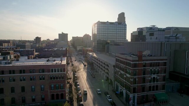 Aerial view of Omaha's skyline with buildings and a street reflecting sunlight, revealing a contrast of shadows and light, Omaha, Nebraska, United States.