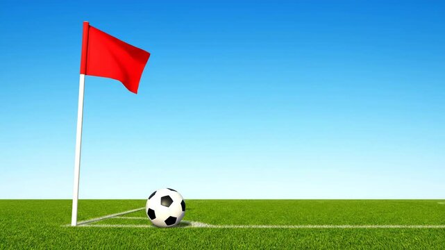 A soccer ball rests near a red corner flag on a vibrant green field. The clear blue sky offers a perfect backdrop for the game.
