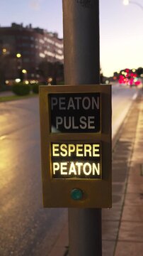A street sign with a light on it that says Peaton Pulse