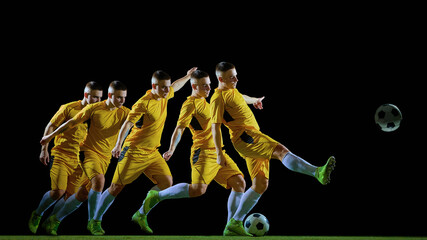 Focused football player striking ball in controlled kicking motion sequence. Concept of body mechanics, football technique training, skill development and professional sports performance. © master1305