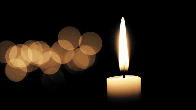 Single burning candle flame on dark background with warm gold bokeh lights creating spiritual atmosphere of hope peace quiet memorial emotional glow