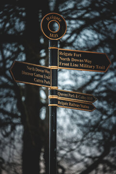 Signpost on Reigate Hill showing North Downs Way and local trails, Surrey, England