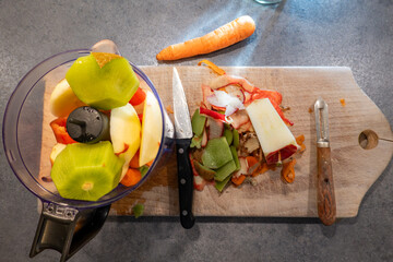 Stockholm, Sweden Kiwi, apples, carrot and ginger on a cutting board to make a smoothie.