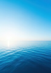 Obraz premium Vast tranquil blue ocean water meets the clear expansive sky at the distant horizon, ideal for backgrounds, copy space, or contemplative themes, seascape, blue, tranquil