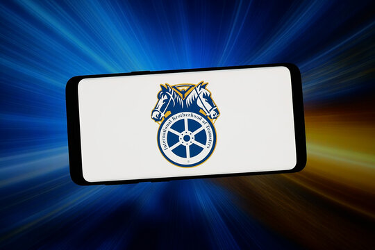 Stuttgart, Germany - 02-06-2026: In this photo illustration, the logo of International Brotherhood of Teamsters (IBT)  is displayed on a smartphone in front of abstract background on computer screen.