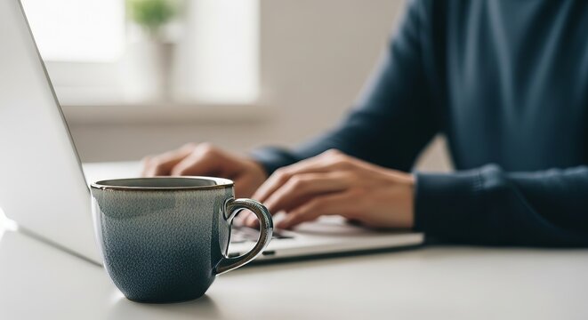 Person Working on Laptop with Coffee.